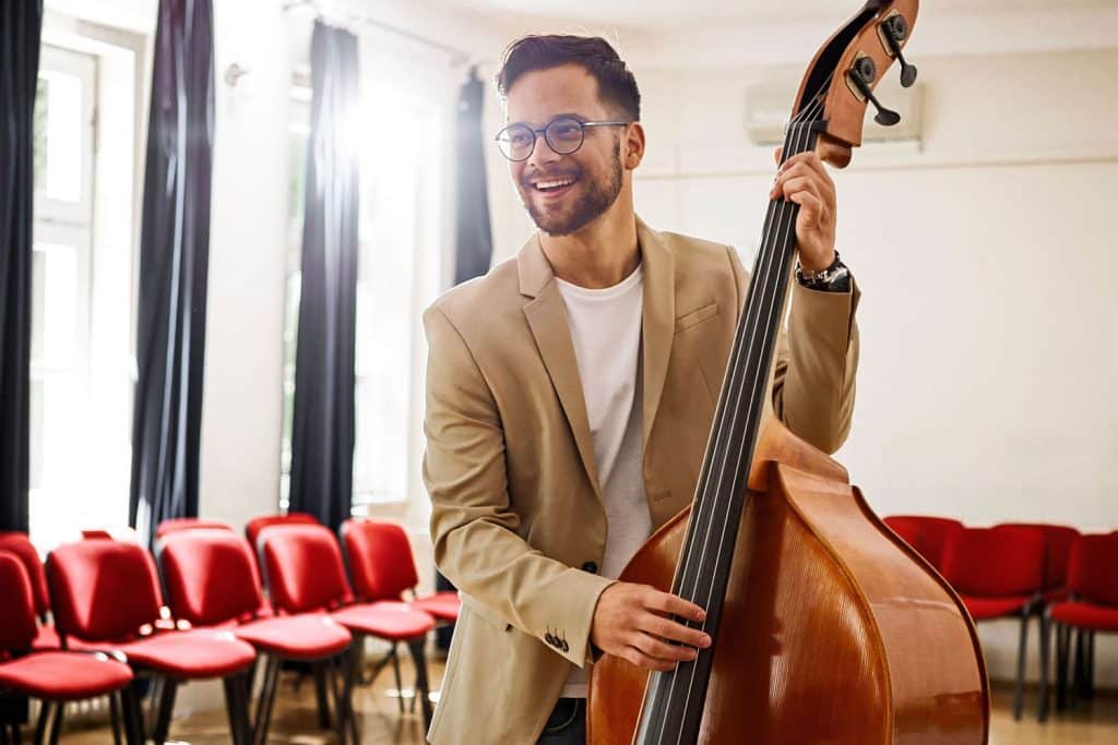 Adult student learning double bass with an experienced double bass teacher