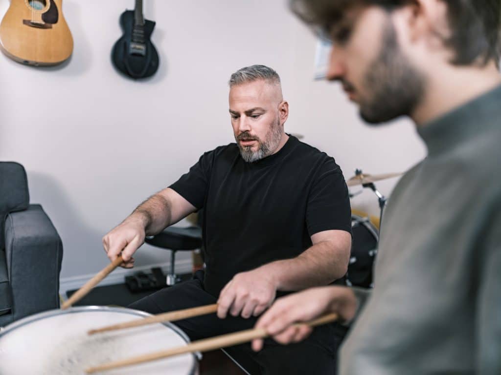Drum teacher helping a student during a drum lesson in Sydney’s Inner West