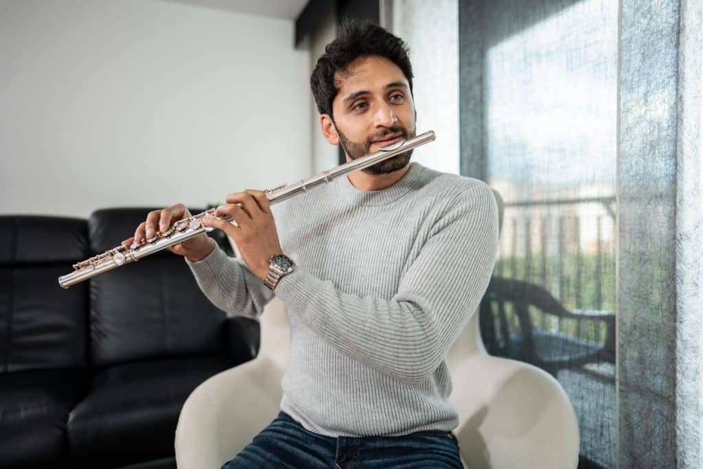 Adult student learning flute with an experienced flute teacher