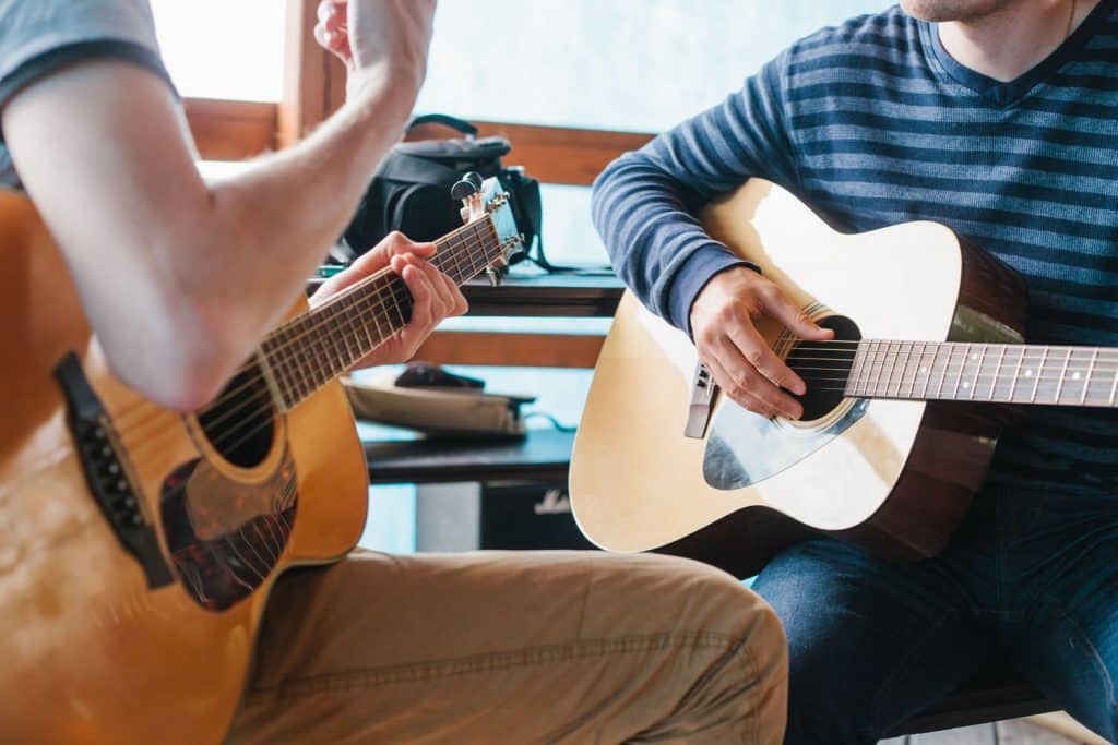 Beginner guitar student learning chords during a private guitar lesson