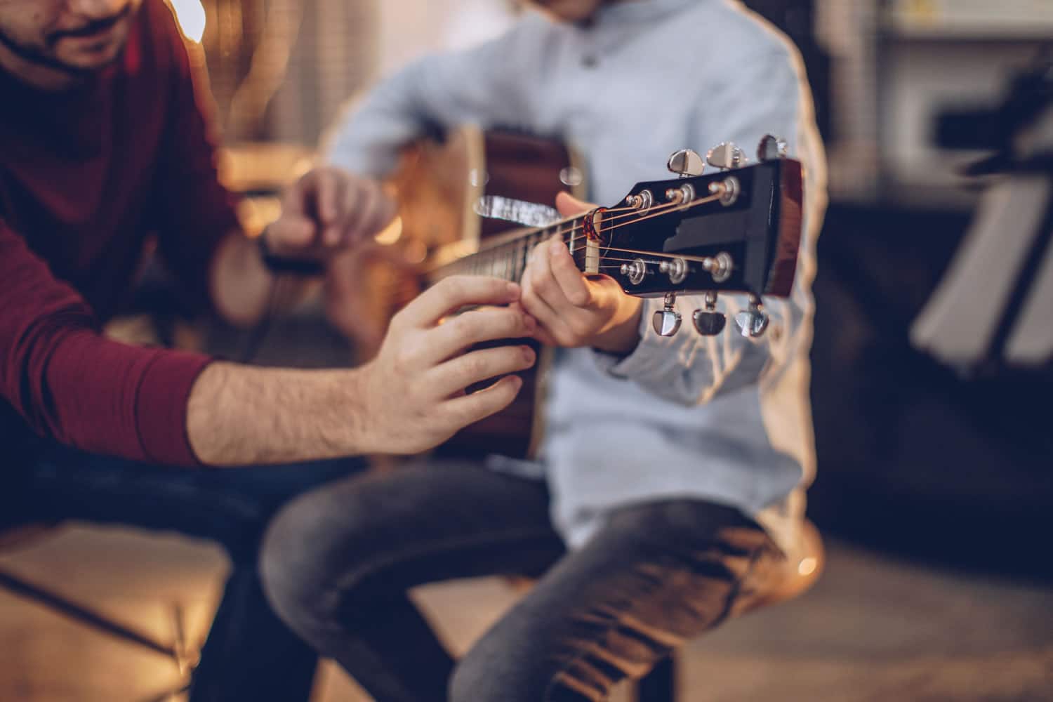 Guitar teacher helping a student during a guitar lesson in Sydney’s Inner West