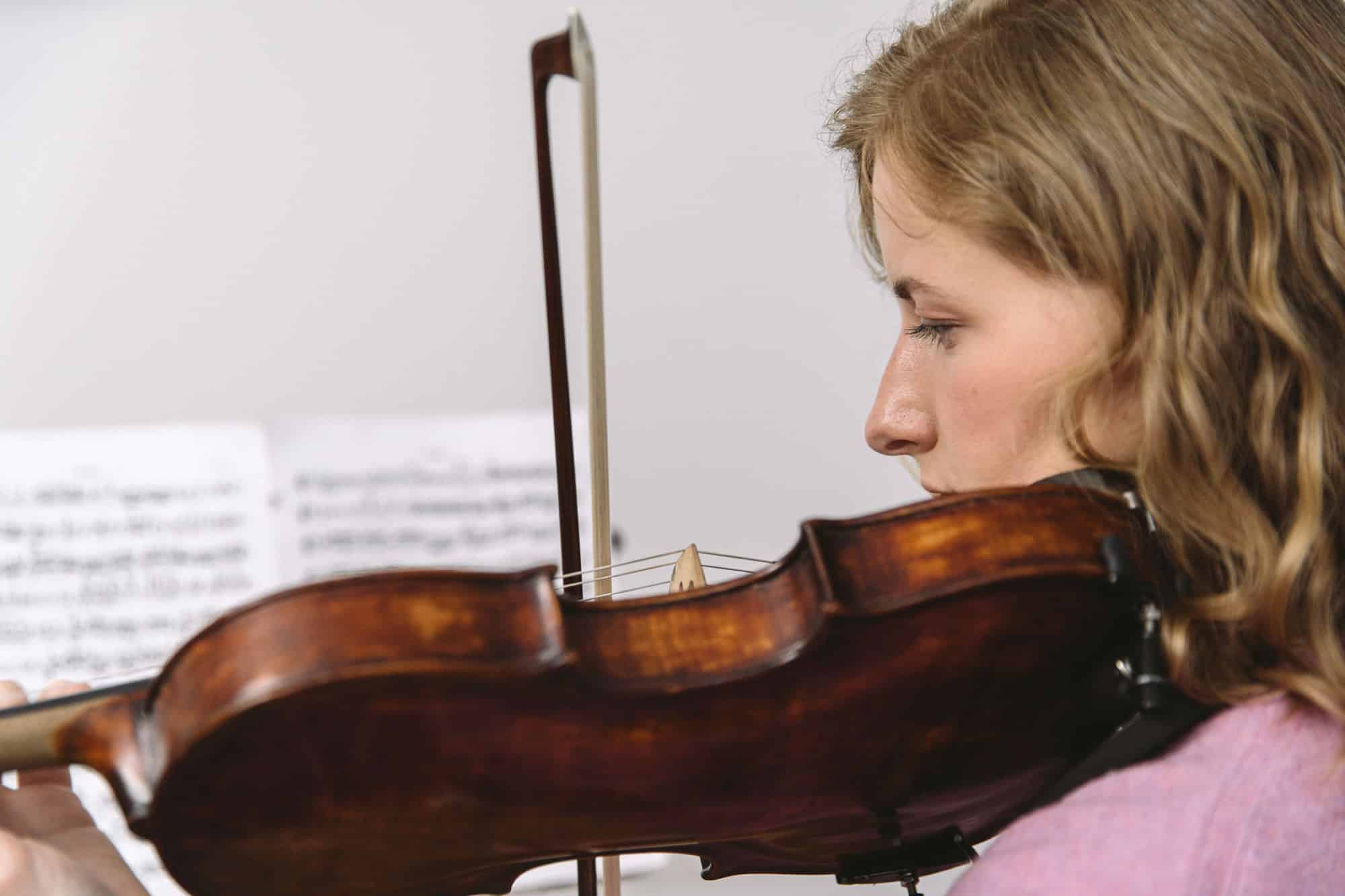 Beginner viola student learning bow hold and posture during a private lesson