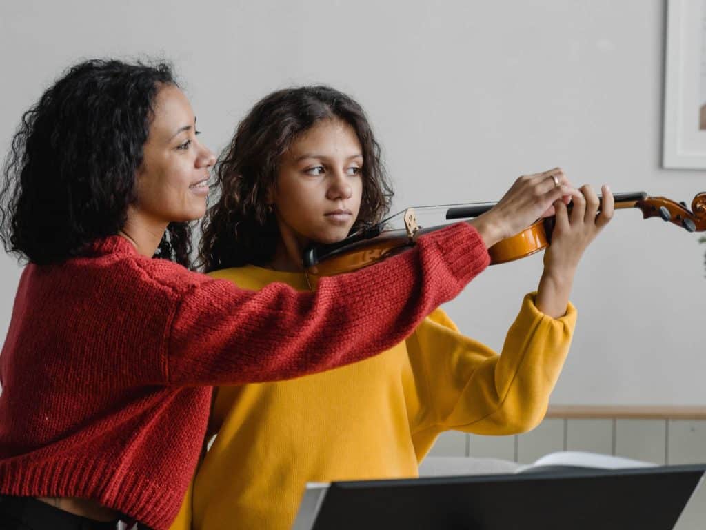 Violin teacher helping a student during a violin lesson in Sydney’s Inner West